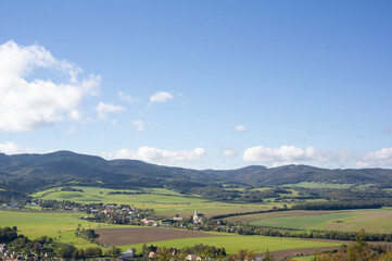 Fototapeta premium Rychleby (Rychlebske mountains), Czech Republic / Czechia - village and rural area is surrounded by beautiful nature - hills and mountains. Sunny landscape during summer