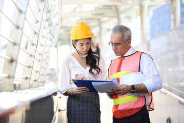 Engineering civil, Construction engineers discussion with architects at construction site or...
