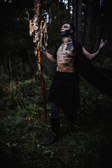 Naklejka premium Sorcerer with marks on his body in the forest