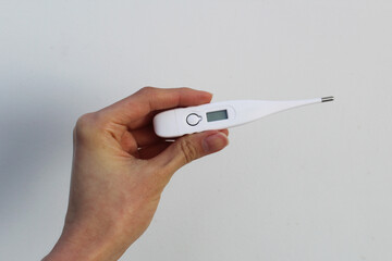 Obraz premium Hand holding a Digital Thermometer 