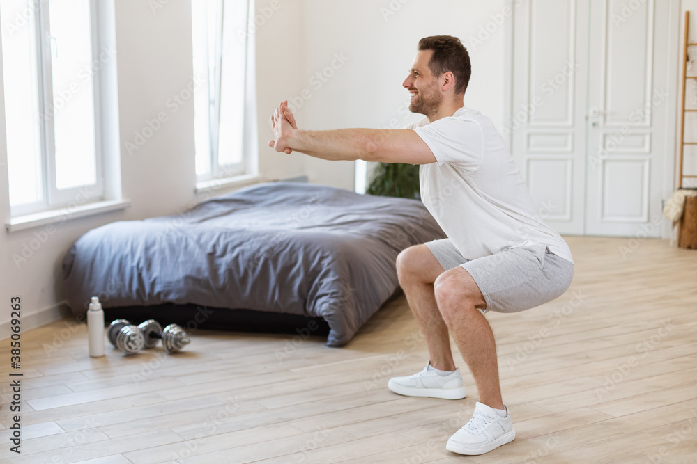 Aufkleber man doing two-legged squat exercise training at home