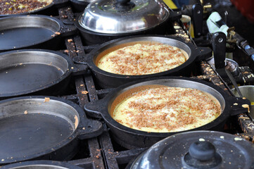 Apam balik or Malaysian Peanut Pancake turnover.  Flour pancake stuffed with sugar and corn topping. Cooked using the hot pan. Famous street food in Malaysia. 