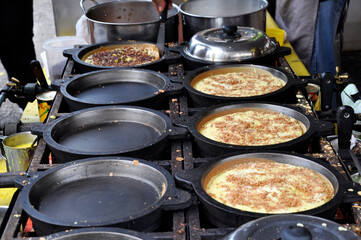 Apam balik or Malaysian Peanut Pancake turnover.  Flour pancake stuffed with sugar and corn topping. Cooked using the hot pan. Famous street food in Malaysia. 