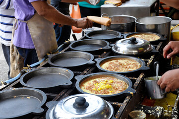 Apam balik or Malaysian Peanut Pancake turnover.  Flour pancake stuffed with sugar and corn topping. Cooked using the hot pan. Famous street food in Malaysia. 