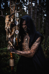 Naklejka premium Sorcerer with marks on his body in the forest