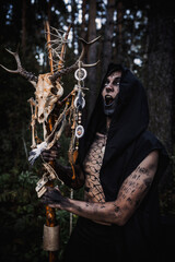 Sorcerer with marks on his body in the forest