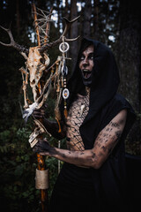 Sorcerer with marks on his body in the forest