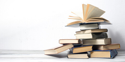 Open book, hardback books on wooden table. Back to school. Copy space