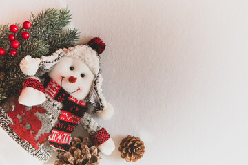 Toy snowman and Christmas decorations on a white background. Decor for the New Year. Place for text.