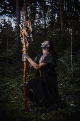 Sorcerer with marks on his body in the forest