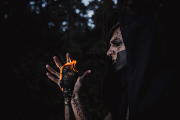 Sorcerer with marks on his body in the forest