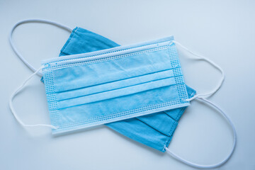Medical protective mask and fabric protective face mask on a blue background