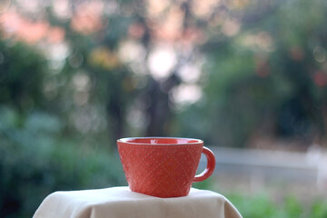 Cup of coffee or tea in a garden. Selective focus.