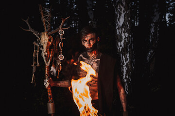 Sorcerer with marks on his body in the forest