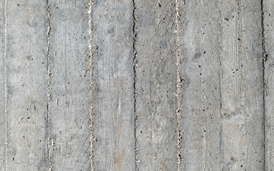 grey concrete wall closeup with wooden planks pattern imprint, seamless background