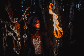 Sorcerer with marks on his body in the forest