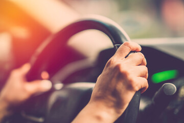 woman hand drive car close up, vintage filter
