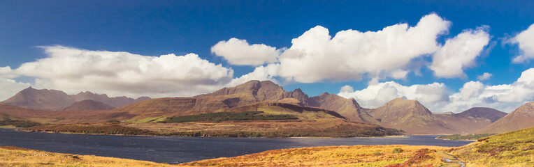 Panoramic view of Bla Bheinn (Blaven) and Cuillin Mountains on beautiful sunny day on Isle of Skye, Scotland, UK
