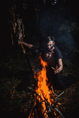 Naklejka premium Sorcerer with marks on his body in the forest