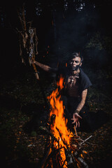 Sorcerer with marks on his body in the forest
