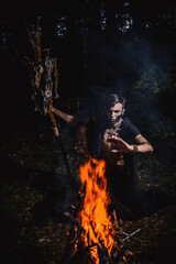 Sorcerer with marks on his body in the forest