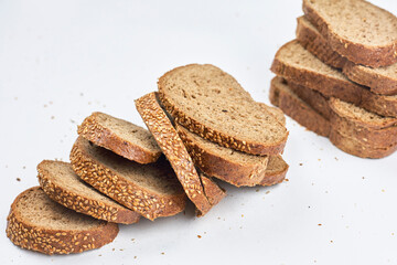 Pile of loaf bread slices on white fabric textile with copy space