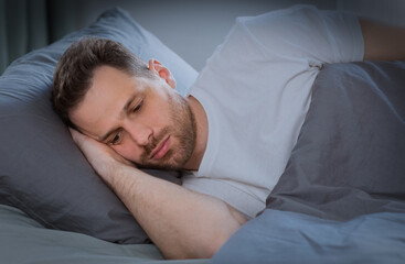 Depressed Man Having Insomnia Lying In Bed At Home