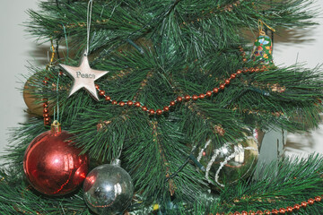 Christmas tree garland and decorations with a silver star on left for holiday themes.