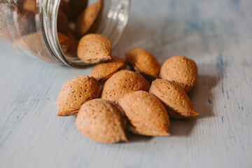 Almonds in a jar on wooden rustic table as background. Organic and healthy food. 