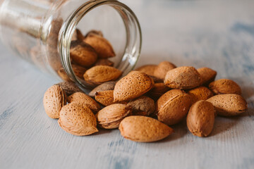 Almonds in a jar on wooden rustic table as background. Organic and healthy food.	