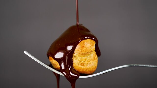 profiterole, choux pastry with chocolate pouring