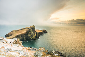 Fototapeta na wymiar Isle of Skye winter landscape - Neist Point lighthouse and storm over ocean