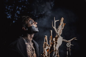 Sorcerer with marks on his body in the forest