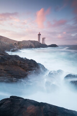 Most popular lighthouse in Europe during stormy weather. Petit Minou Lighthouse at sunset with red...