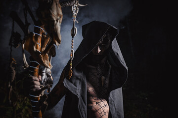 Sorcerer with marks on his body in the forest