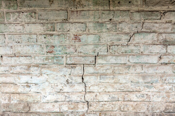 Old brickwork with crumbling plaster. Building wall. Graphic resources. Background. Vintage. Retro.