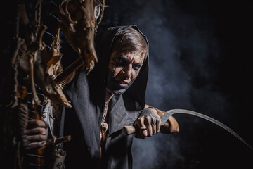 Sorcerer with marks on his body in the forest