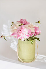 Obraz na płótnie Canvas box with fresh pink peonies close-up. soft focus, vintage toning, wedding invitation concept