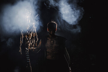 Sorcerer with marks on his body in the forest