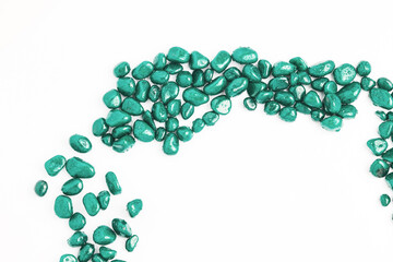 texture of stones on a white background. beautiful turquoise pebbles in water drops. top view, copy space