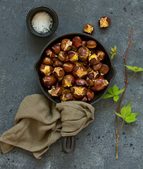 Roasted chestnuts on an old board. Selective focus.
