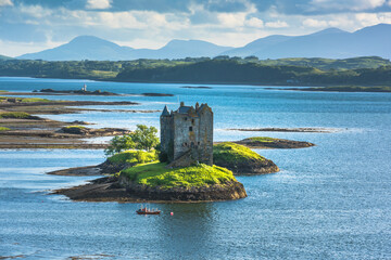Castle on island - Castle Stalker - a picturesque castle surrounded by water located 25 miles north of Oban on the west coast of Scotland © lukasz_kochanek