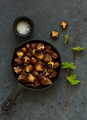 Roasted chestnuts on an old board. Selective focus.