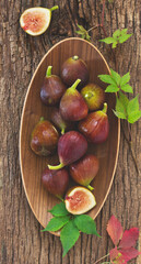 Fresh fig fruits on a wooden background.