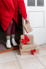 Obraz premium Deliver hands gifts package box red new year delivery door