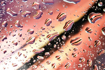 Water droplets on glass - red background