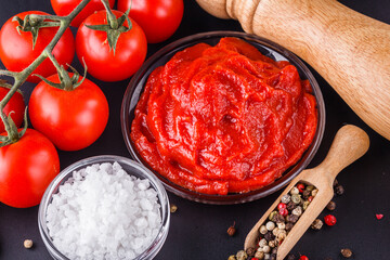 fresh natural tomato paste on black background