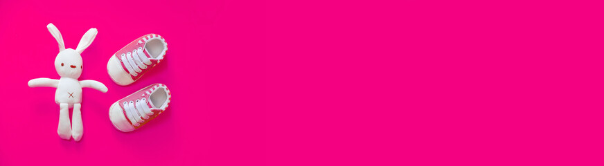 Shoes for newborns on a yellow background. Selective focus.