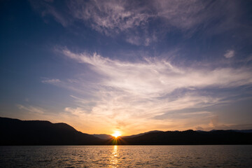 Naklejka na ściany i meble beautiful sunrise over lake and mountain