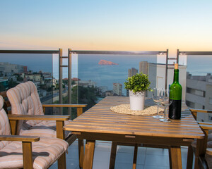 table and chairs on the terrace with the sea view